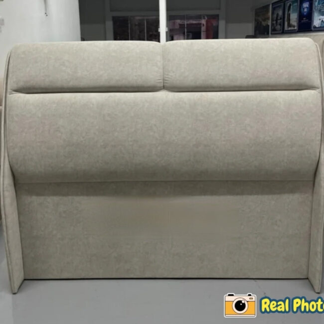 Beige upholstered headboard in a room setting