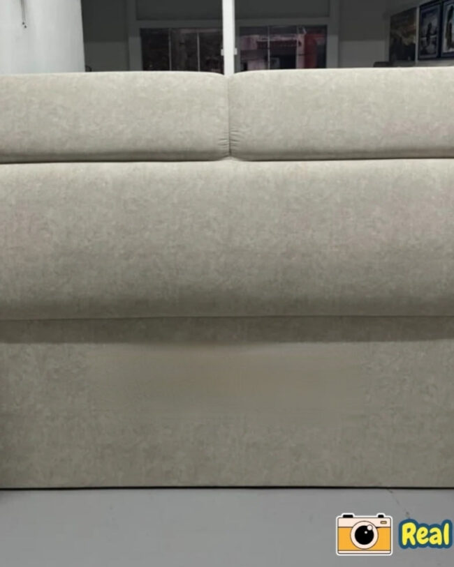 Beige upholstered headboard in a room setting