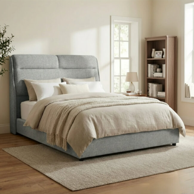 Gray upholstered bed with beige bedding in a bedroom setting.