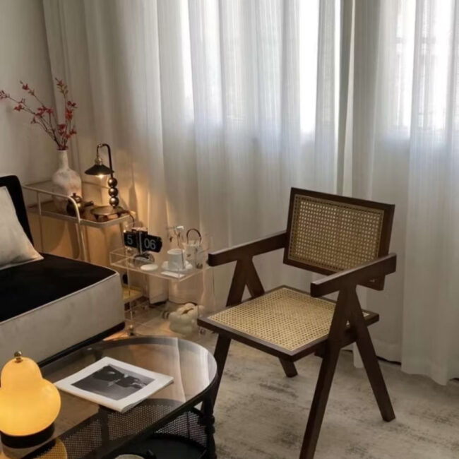 solid wood Dining chair made from teak wood and rattan, placed in a living room beside a table. Samz Design home of custom furniture Malaysia