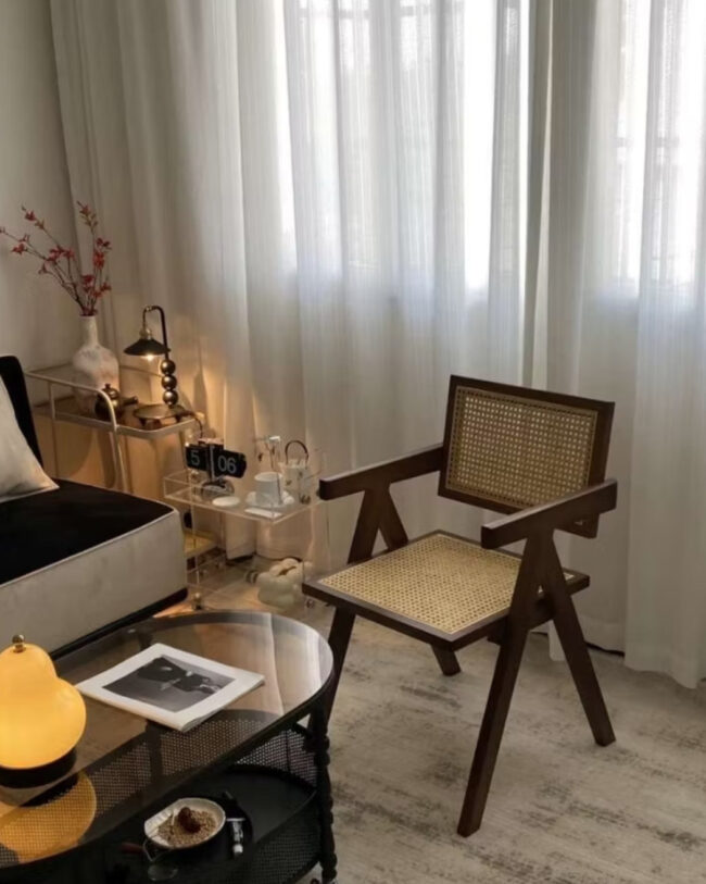 solid wood Dining chair made from teak wood and rattan, placed in a living room beside a table. Samz Design home of custom furniture Malaysia