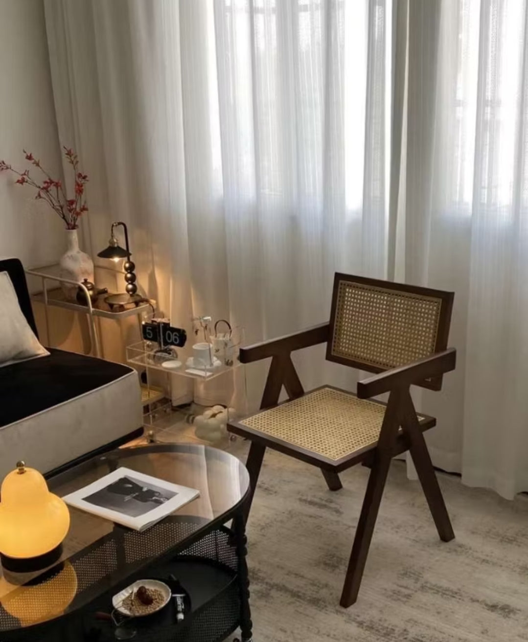 solid wood Dining chair made from teak wood and rattan, placed in a living room beside a table. Samz Design home of custom furniture Malaysia