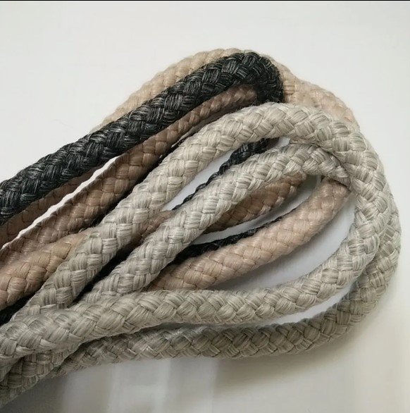 Close-up of braided olefin rope in grey, beige and black used for outdoor rope furniture